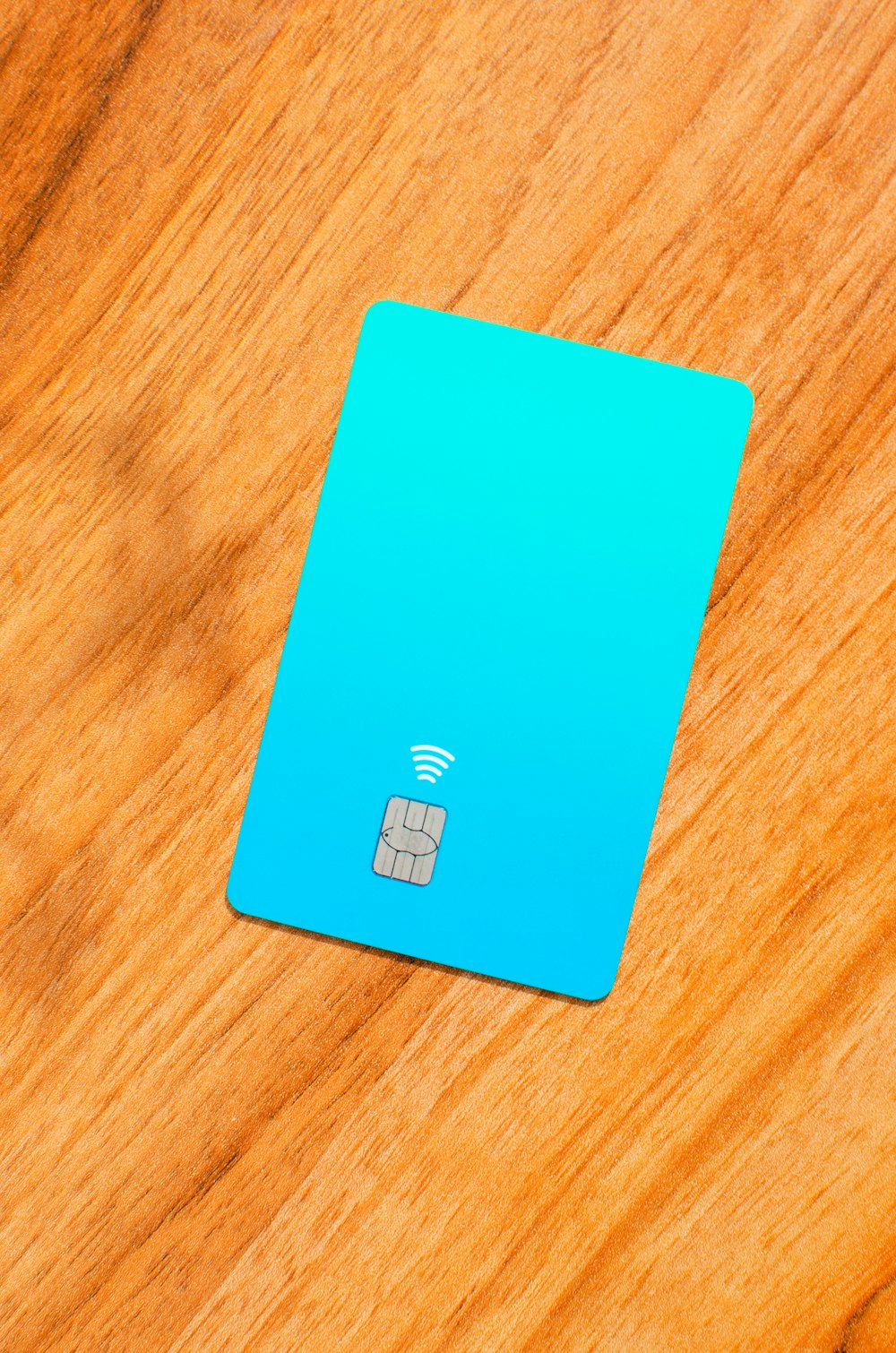 a blue sim card sitting on top of a wooden table