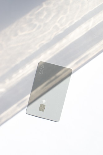 a silver credit card sitting on top of a table