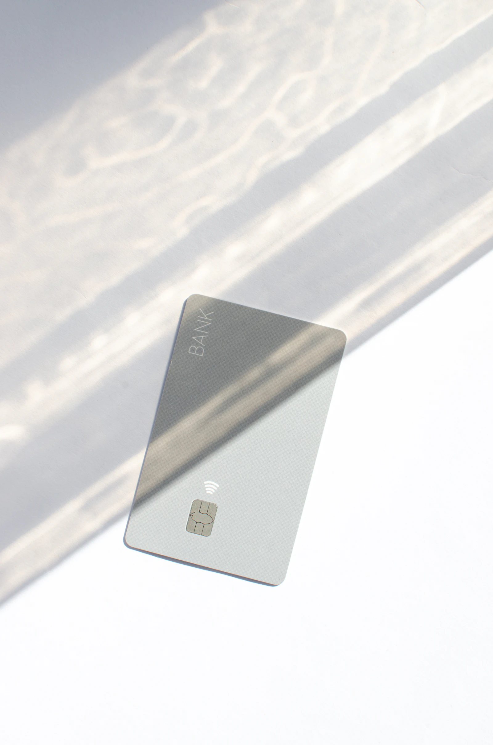 A clean contactless payment card on a bright white surface