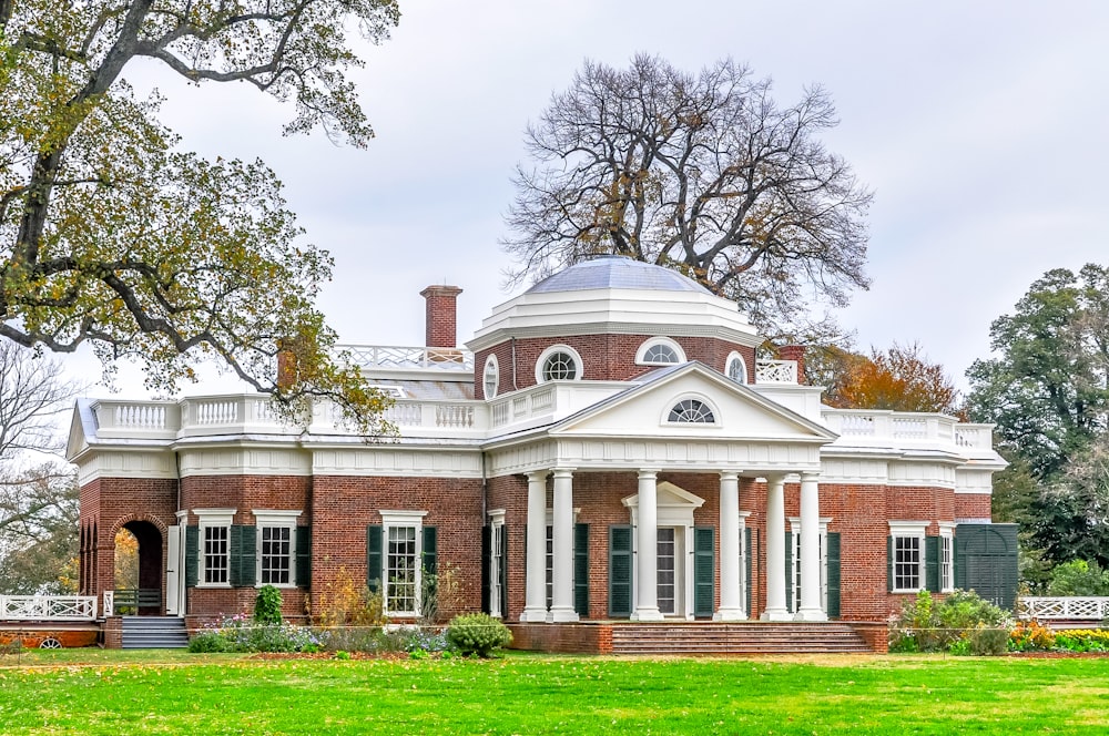 a large red brick house with a white roof