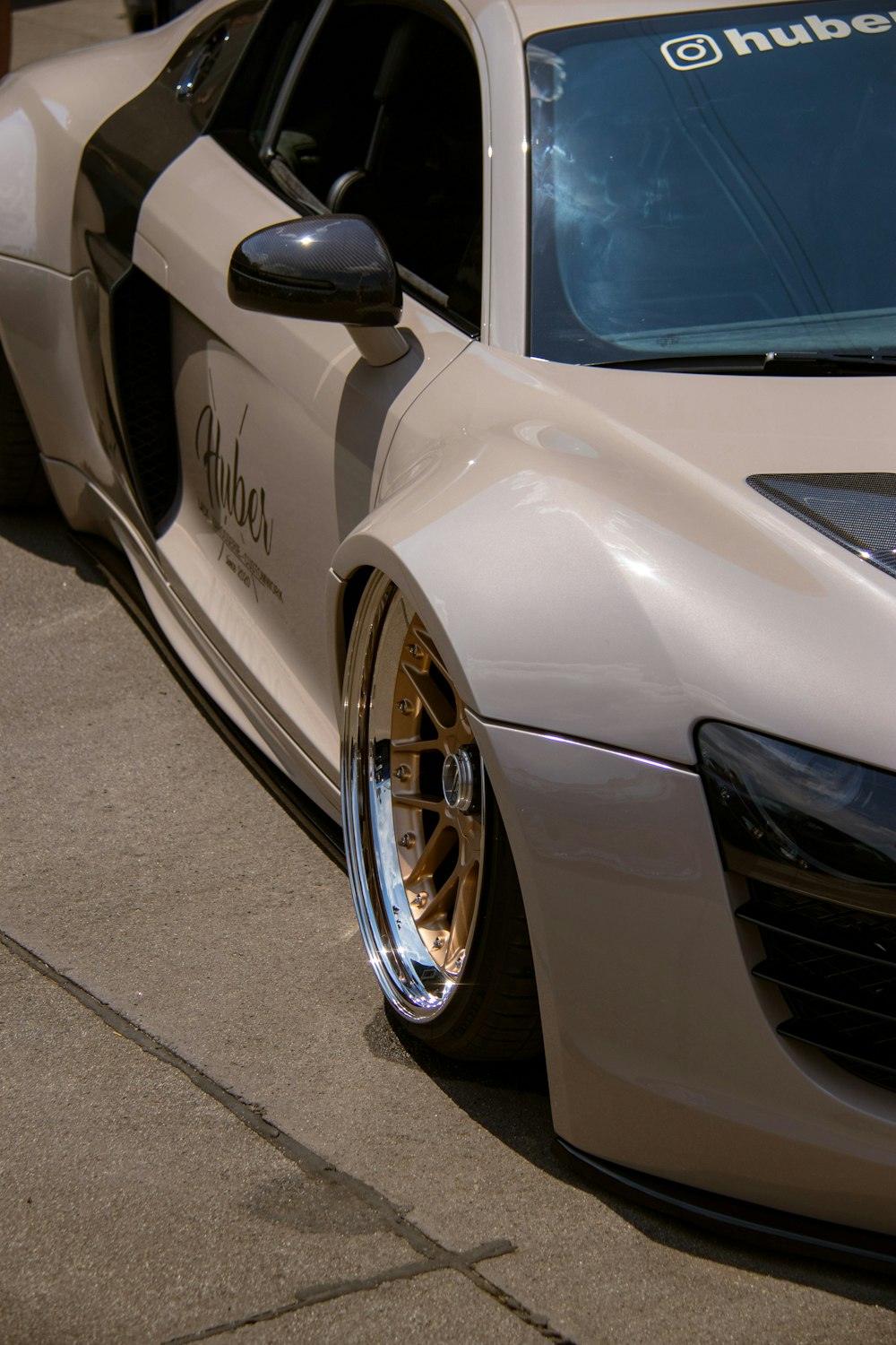 a white sports car parked on the side of the road