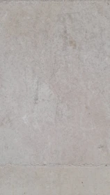 Close-up of waterproof sealant being applied to a basement wall.