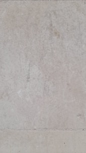 A close-up of a waterproofing membrane being applied to a basement wall.