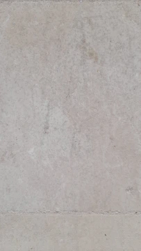 A close-up of a foundation wall being waterproofed with a protective coating in a residential building.