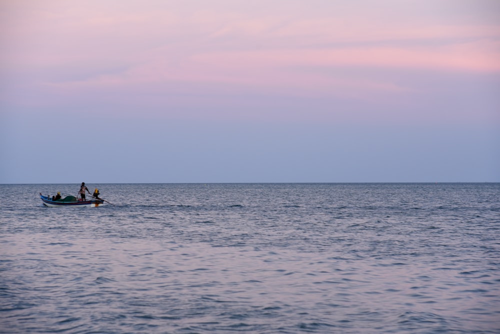 two people in a small boat in the ocean