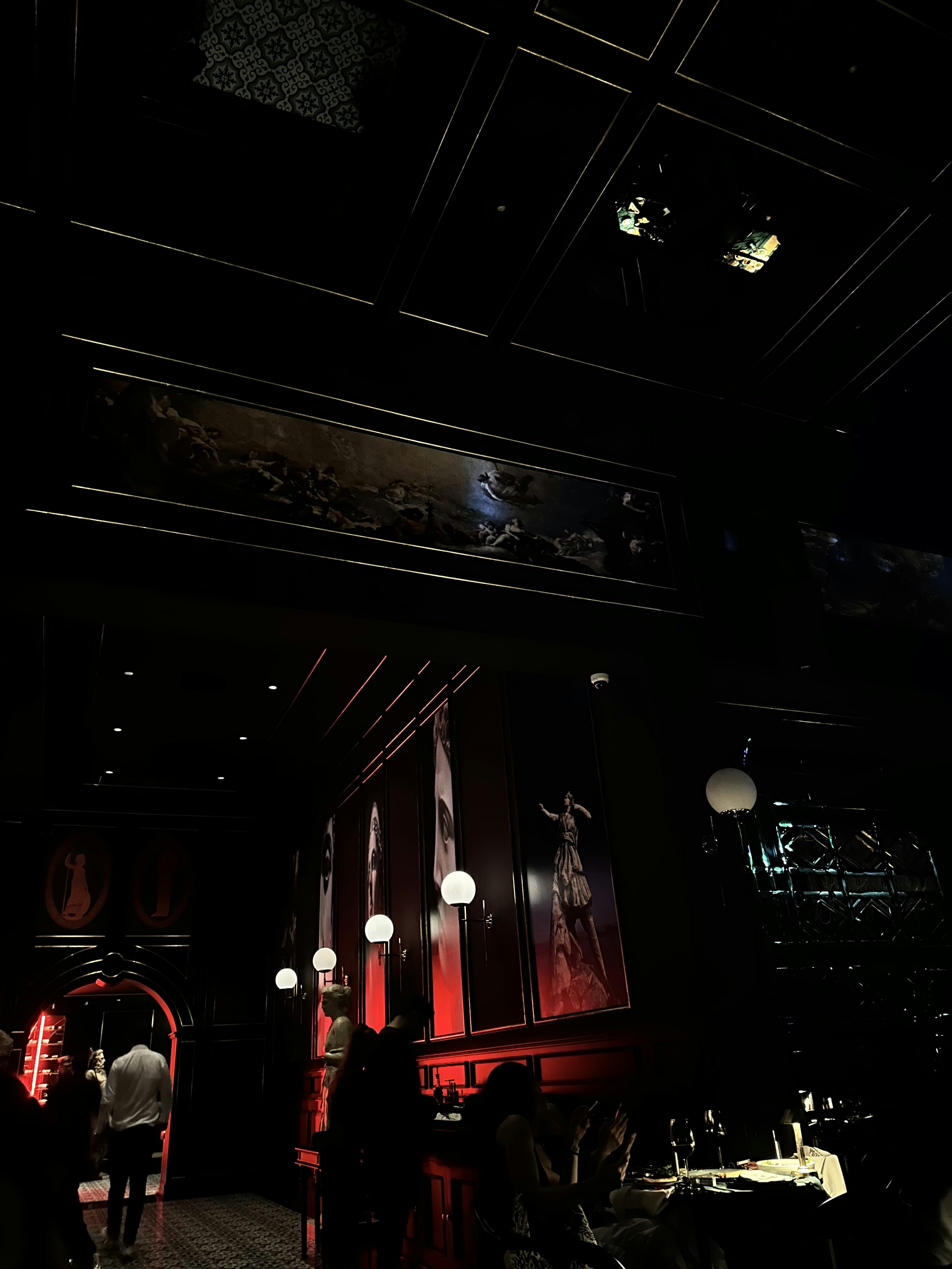 a dimly lit restaurant with people sitting at tables