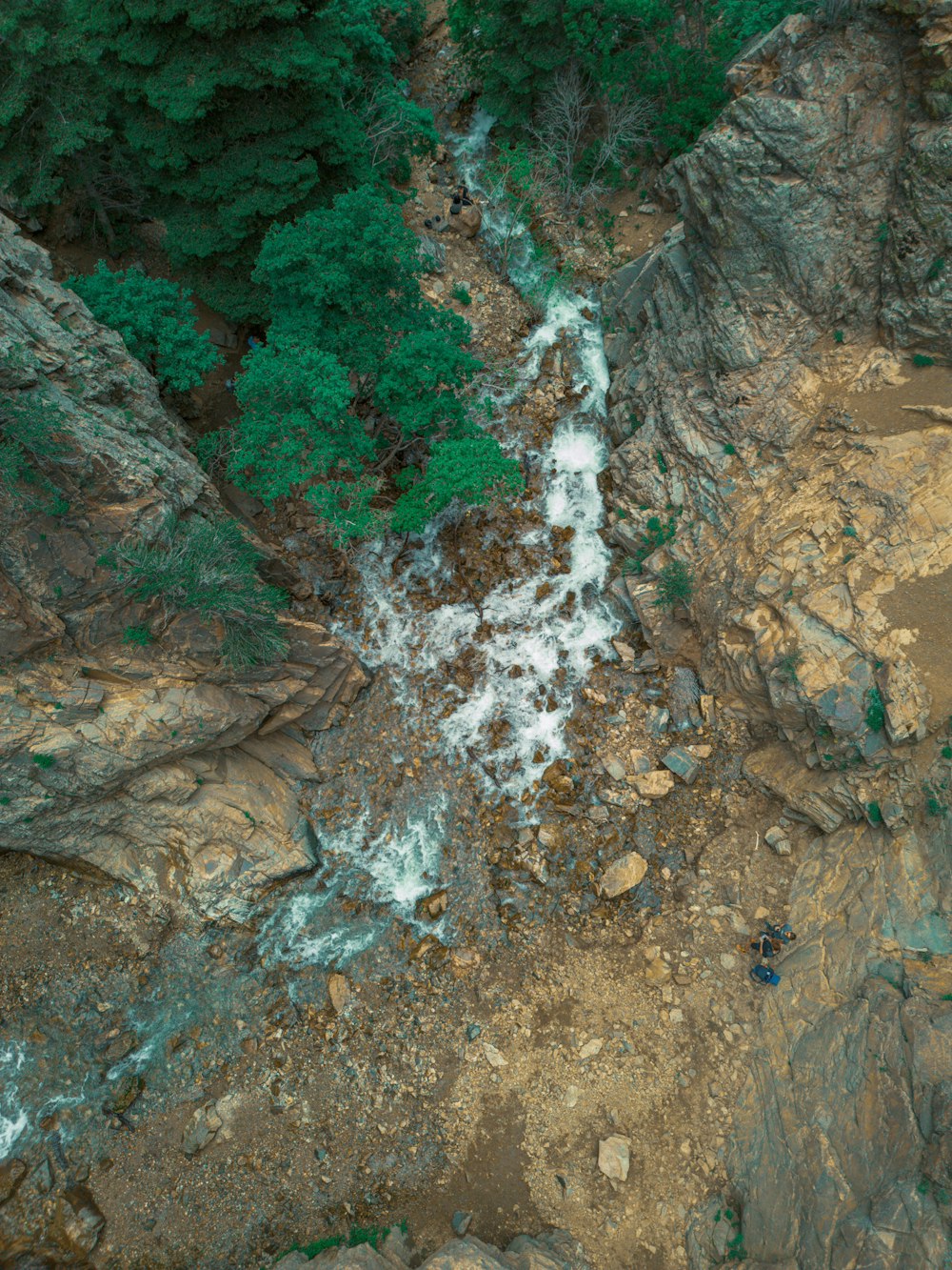 an aerial view of a river running through a rocky area