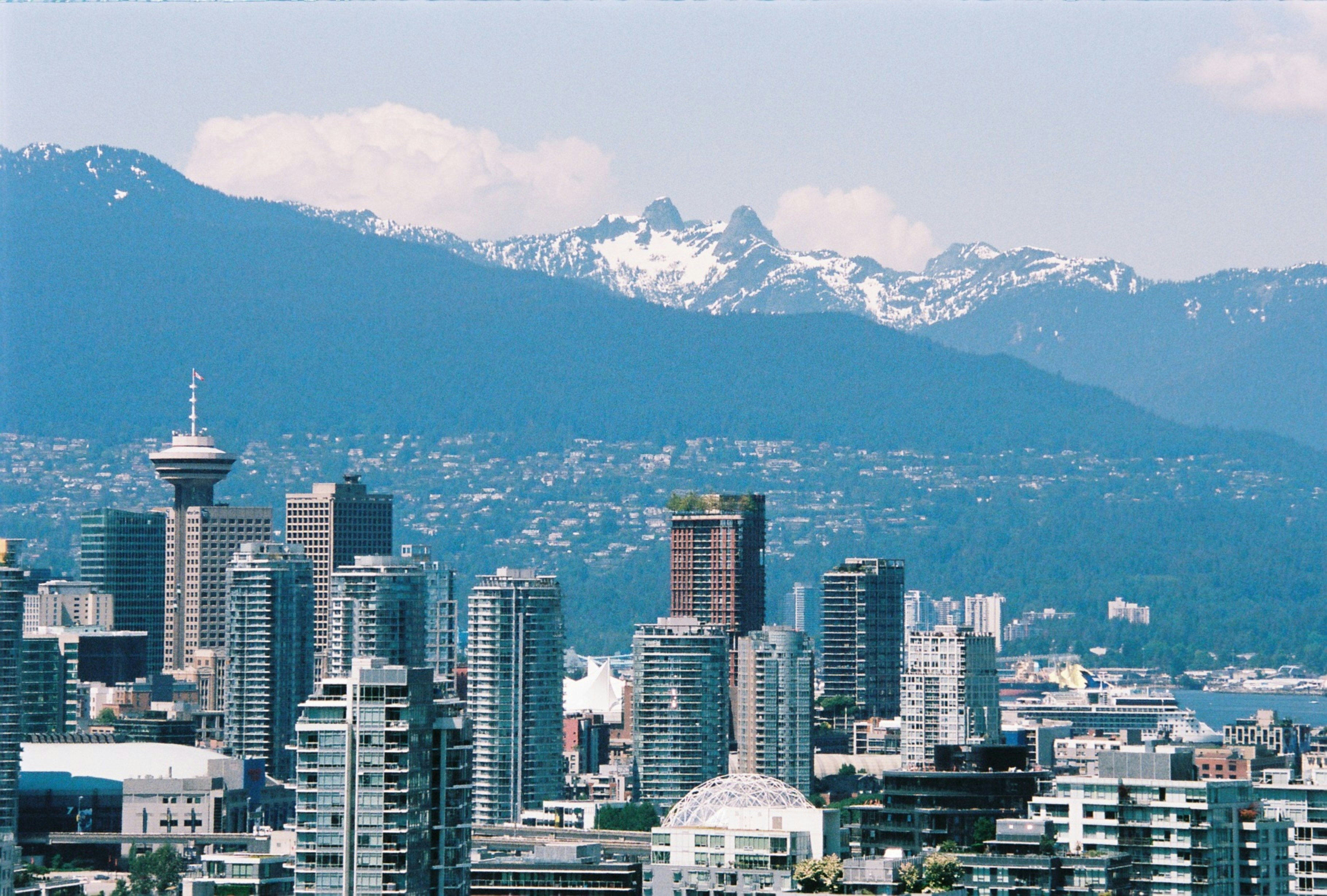 a view of a city with mountains in the background