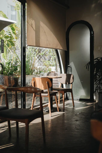 A warm, inviting community gathering in a bright room with open windows and natural light