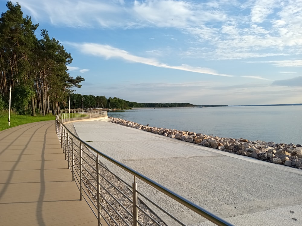 a long walkway next to a body of water