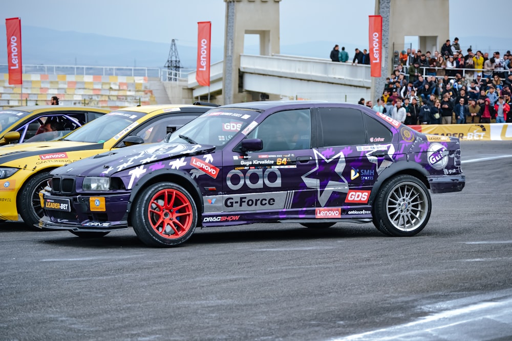 a purple car driving down a race track