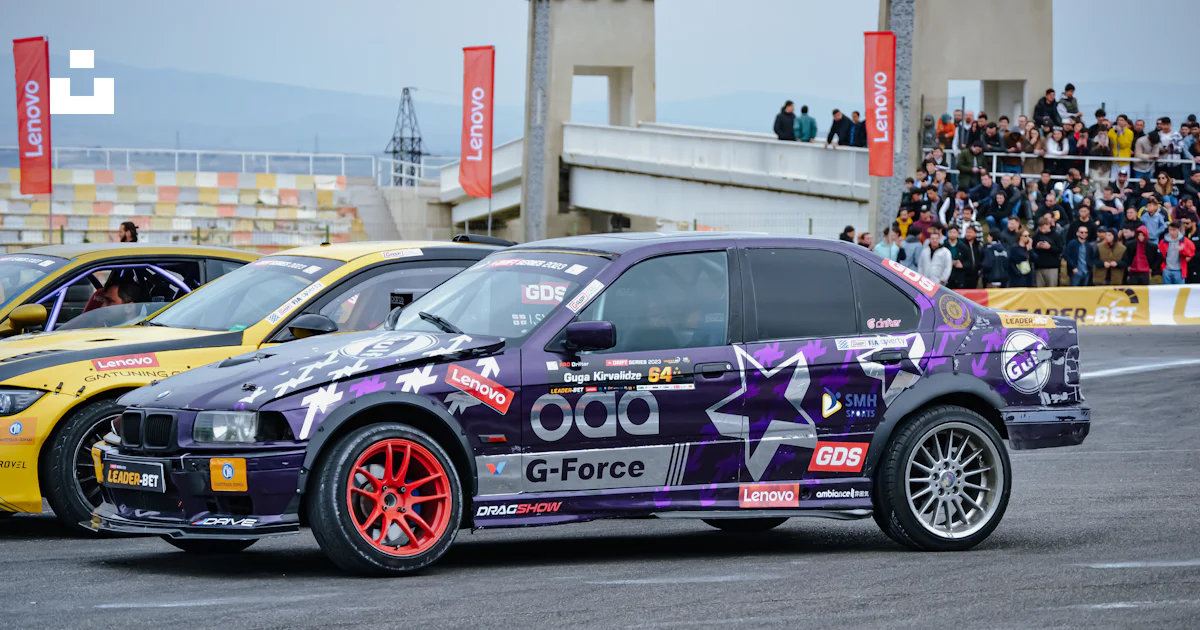 A purple car driving down a race track photo – Free Rustavi ...