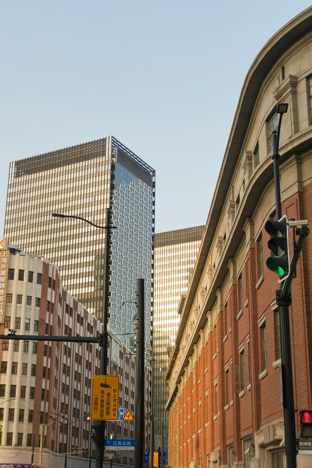 a traffic light on a city street next to tall buildings