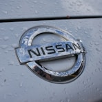 a close up of a nissan emblem on a car