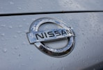 a close up of a nissan emblem on a car