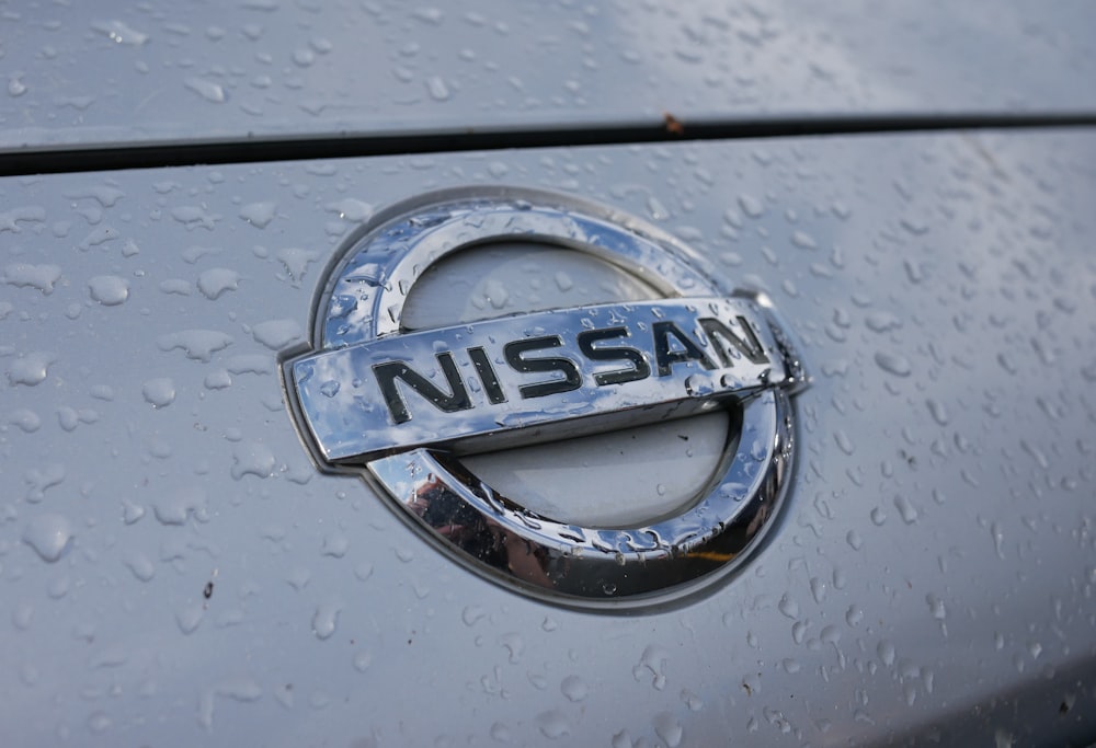 a close up of a nissan emblem on a car