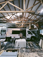 a white van parked inside of a building under construction