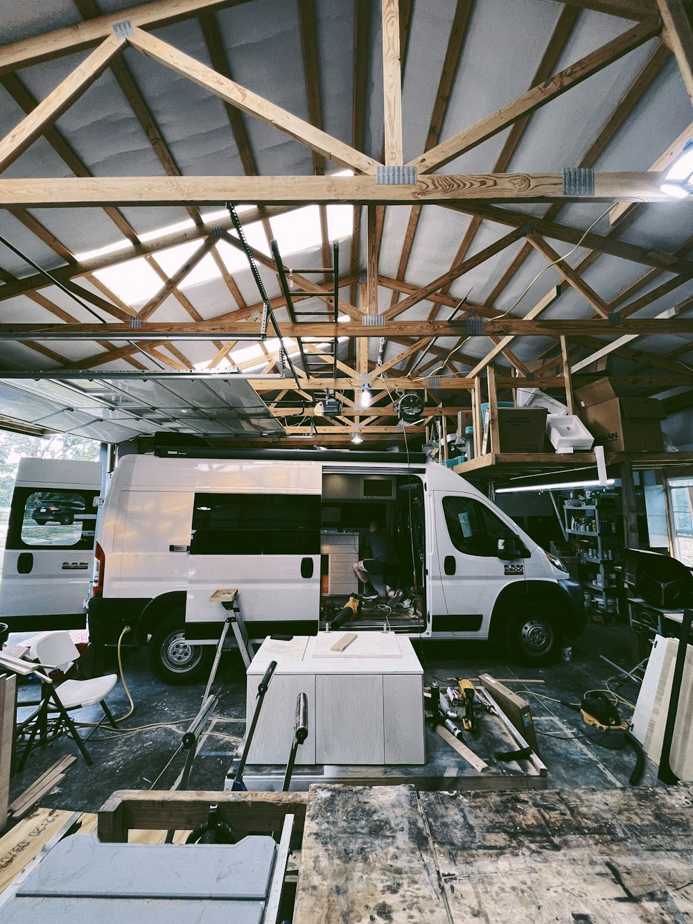 a white van parked inside of a building under construction