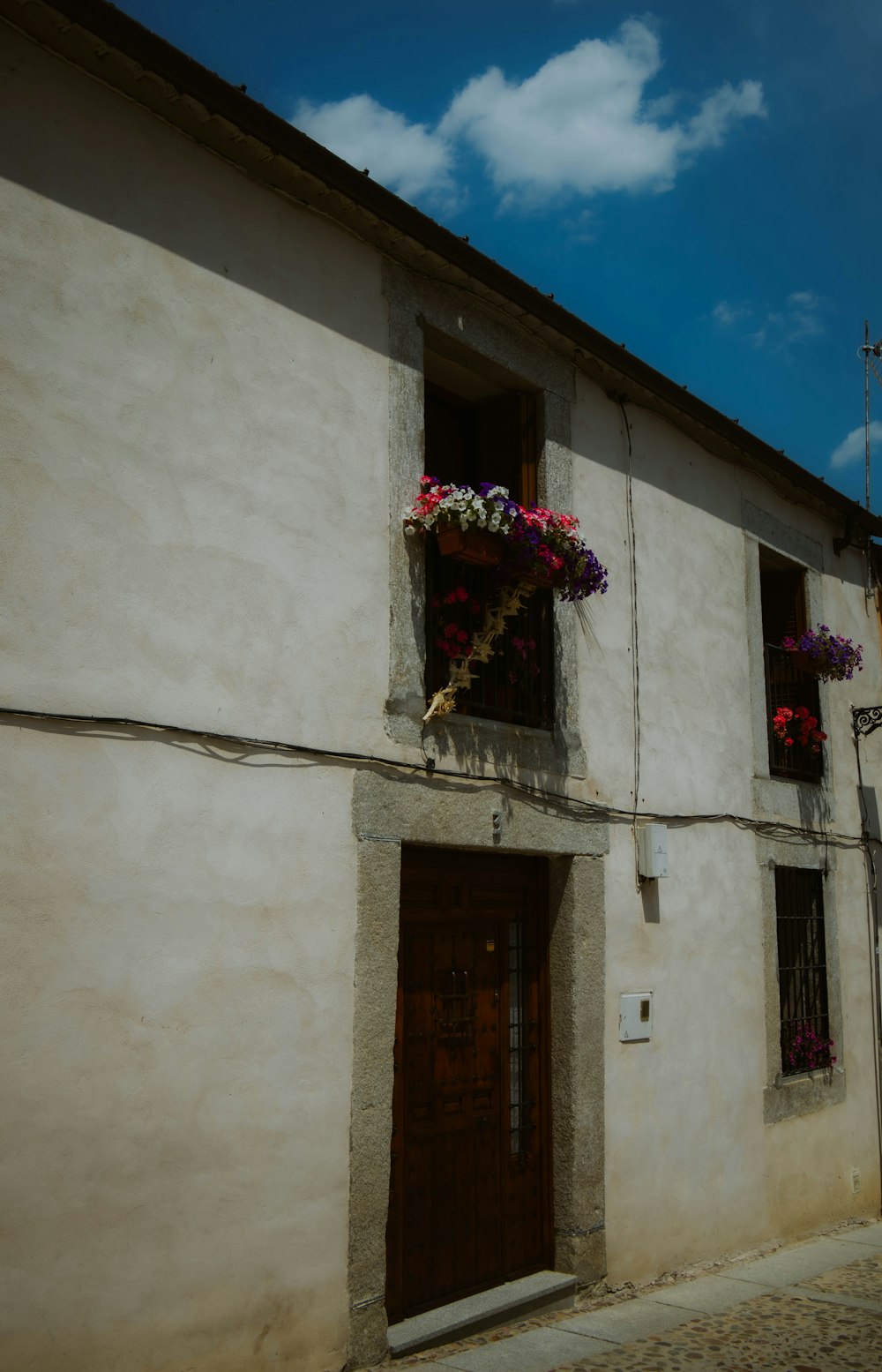 a building with flowers in a window box