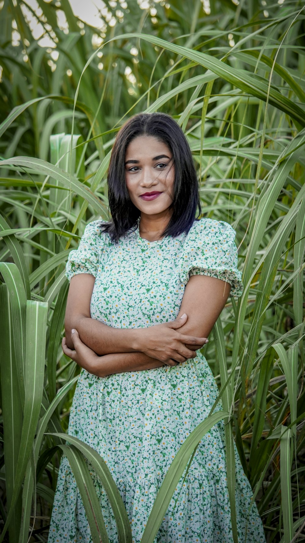 a woman standing in a field of tall grass