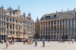 Historic buildings lining a lively square filled with locals and visitors enjoying the day