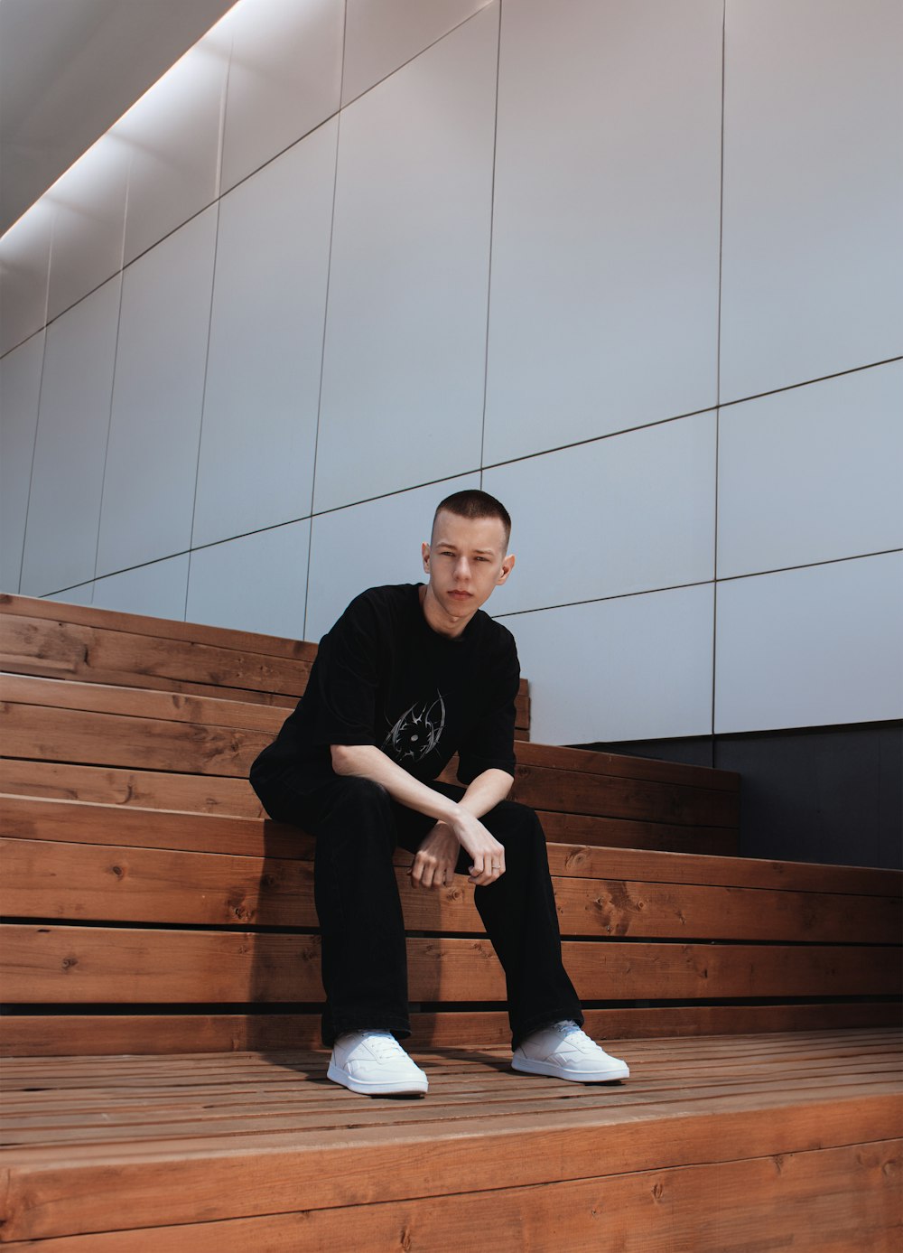 a man sitting on some steps with his legs crossed