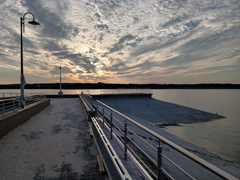 the sun is setting over a large body of water