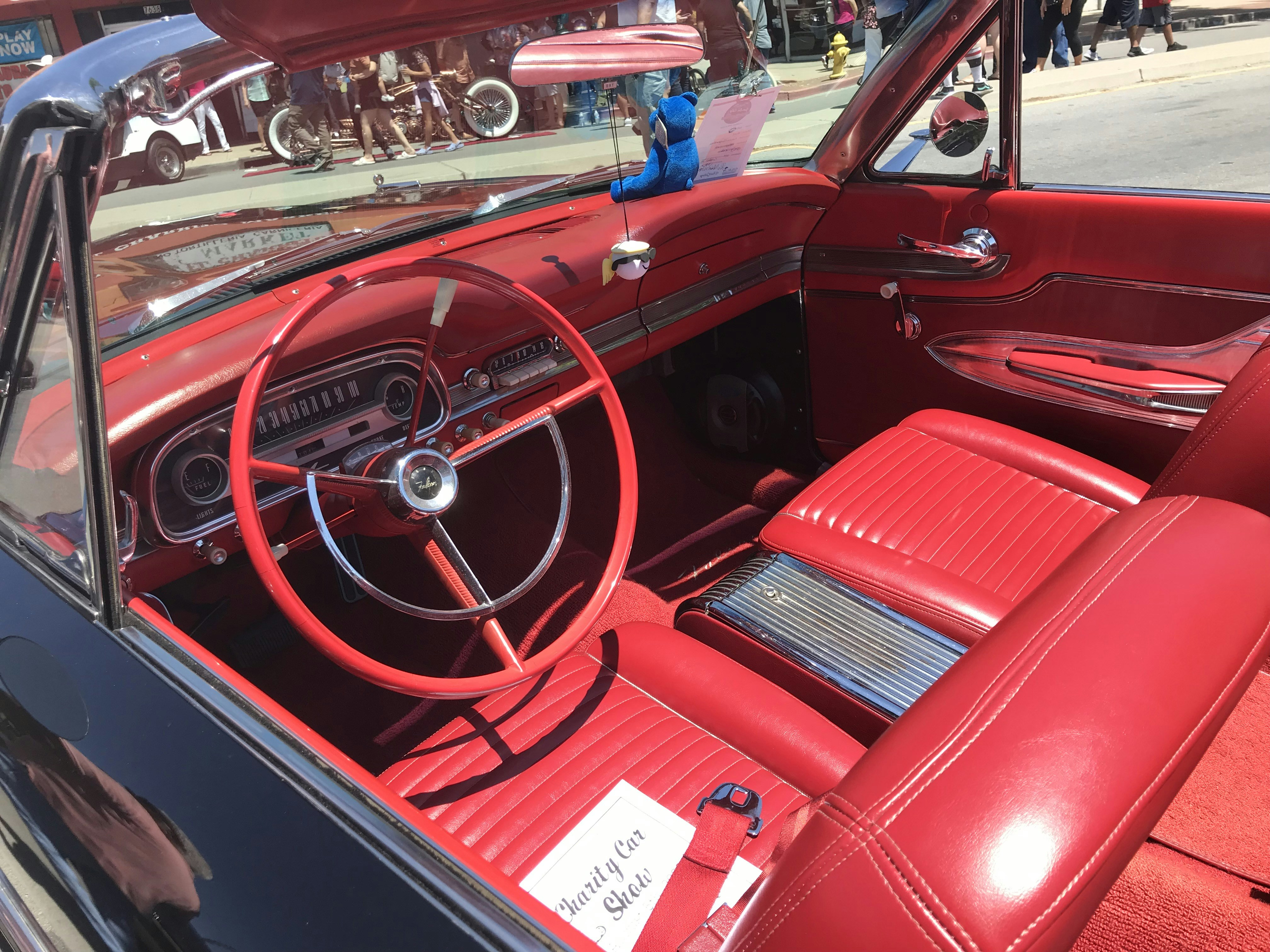a red car with a steering wheel and dashboard