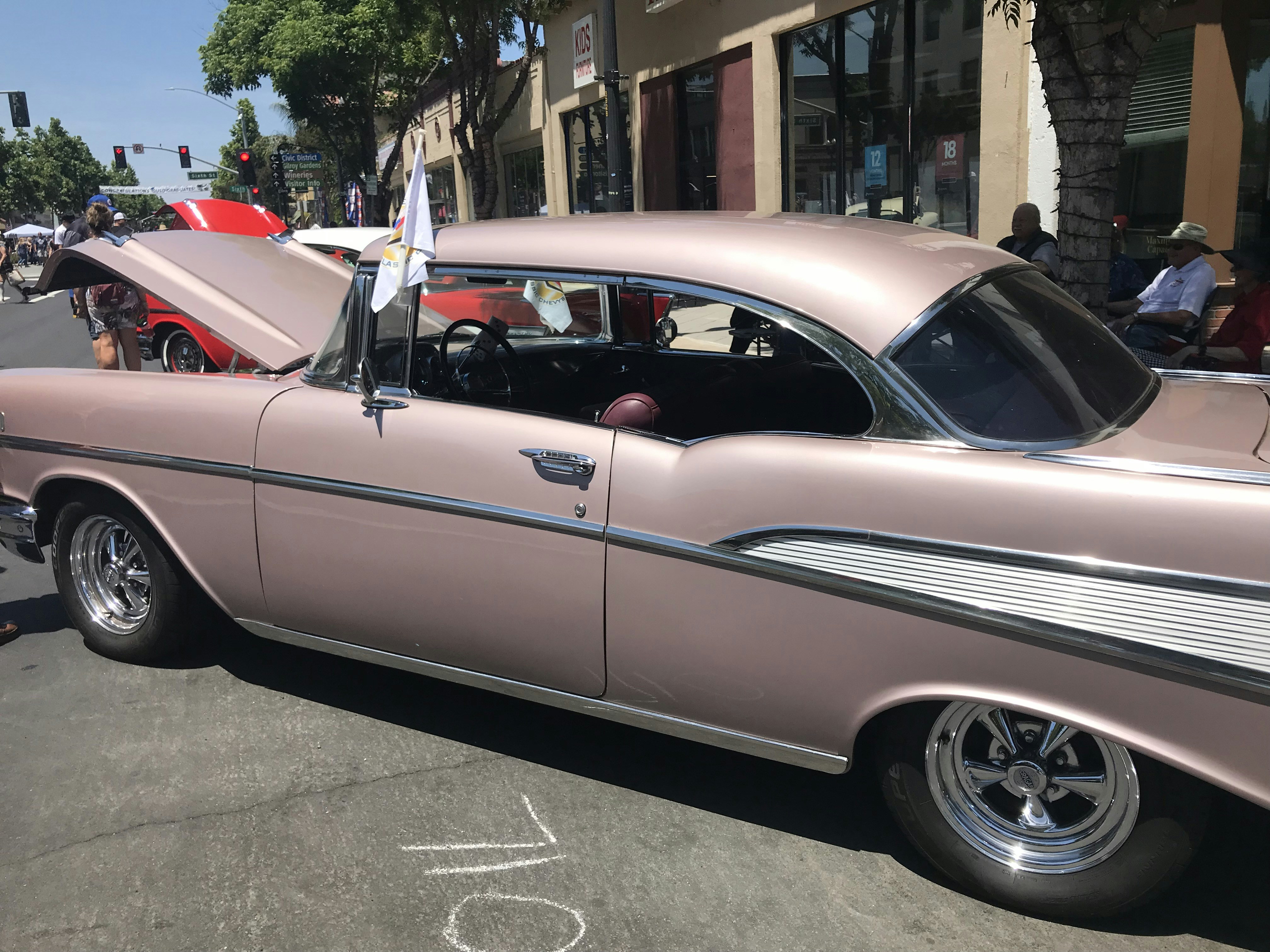 a pink car parked on the side of the road