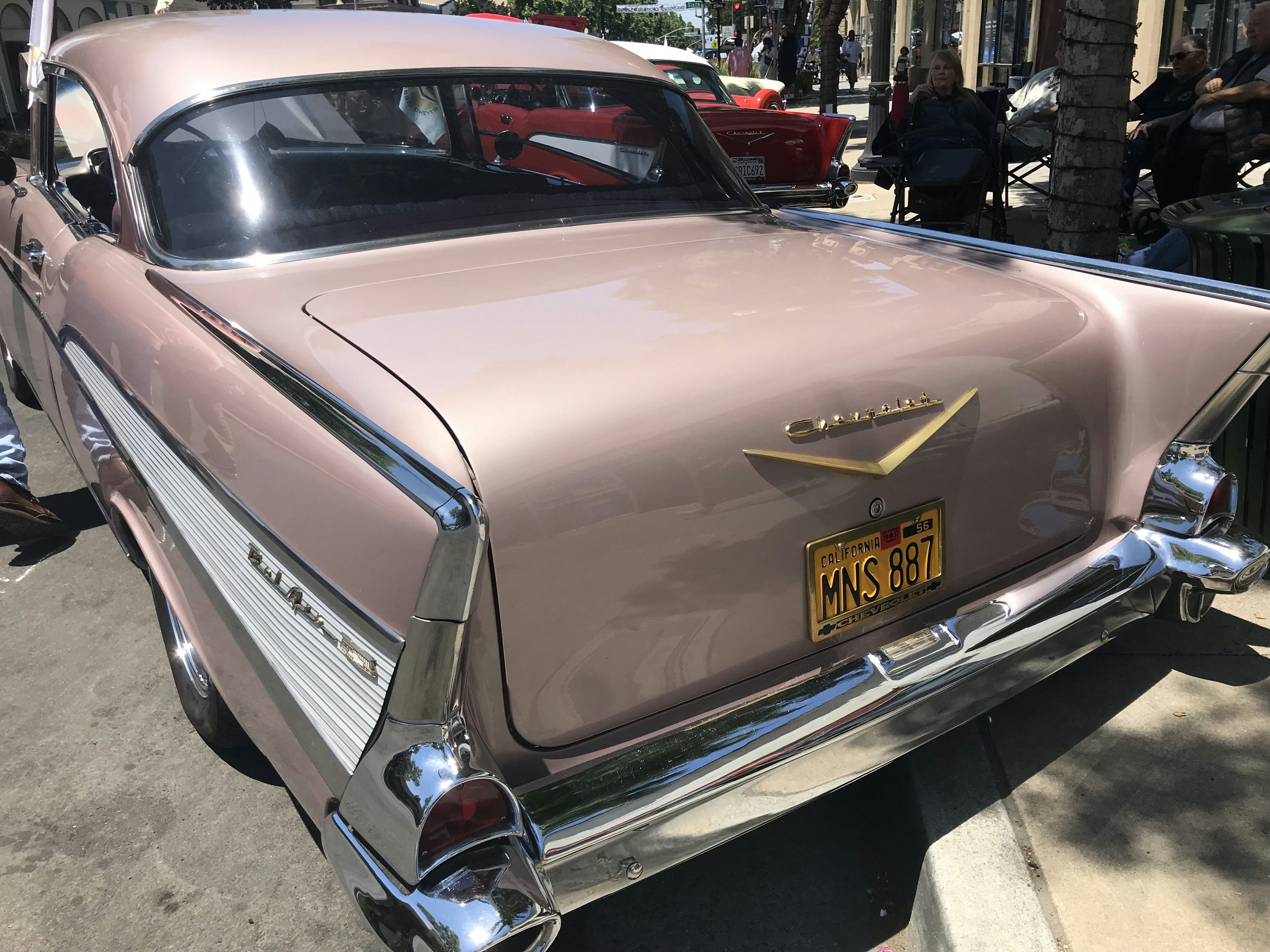 a pink car parked on the side of the road