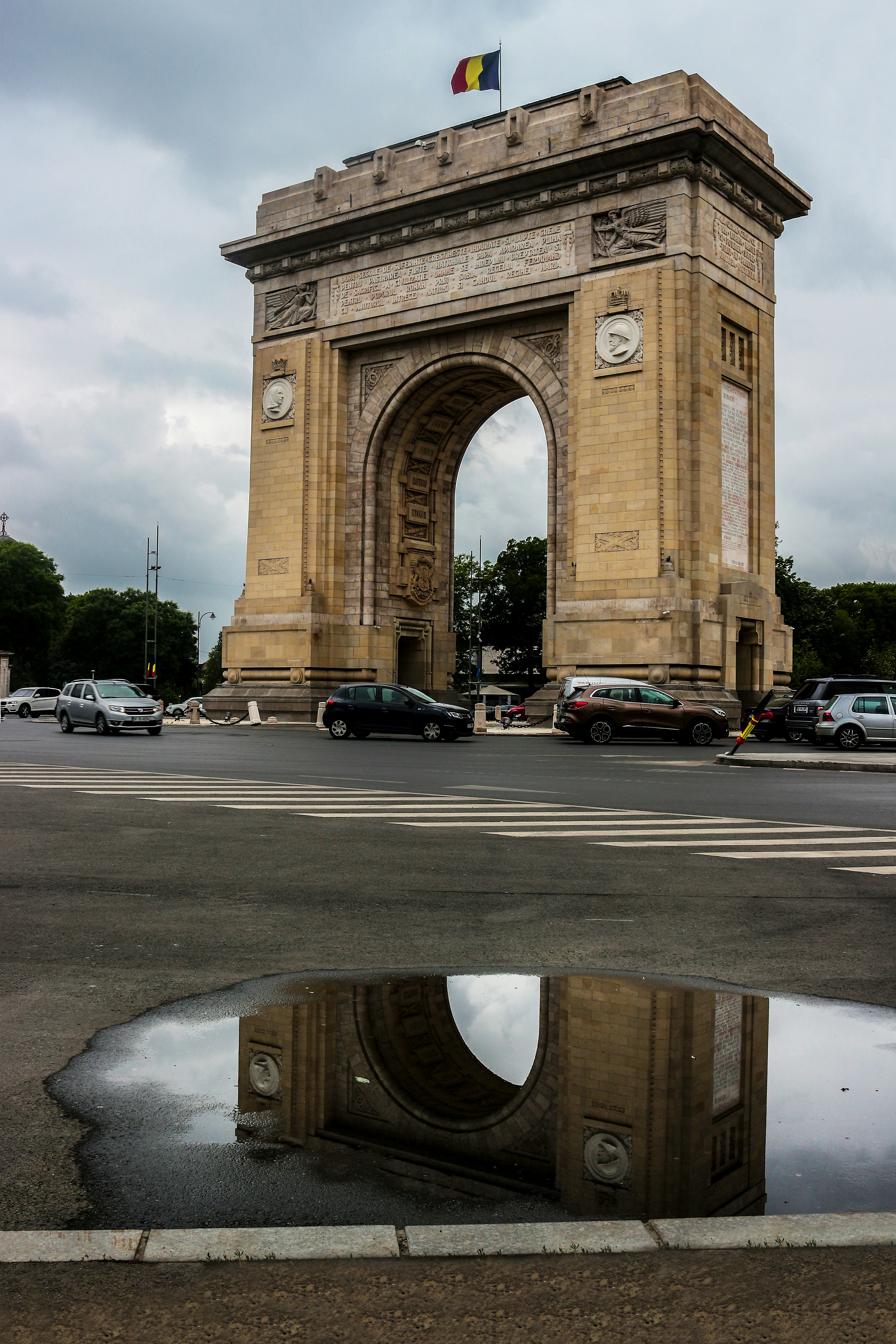 a reflection of cars in a puddle of water