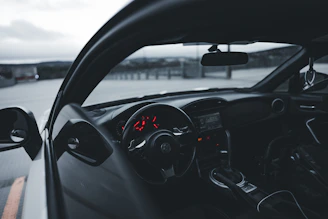 Close-up of a sleek car dashboard with glowing premium instrument panel lights.