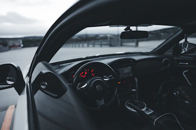 Close-up of a sleek car dashboard with glowing premium instrument panel lights.