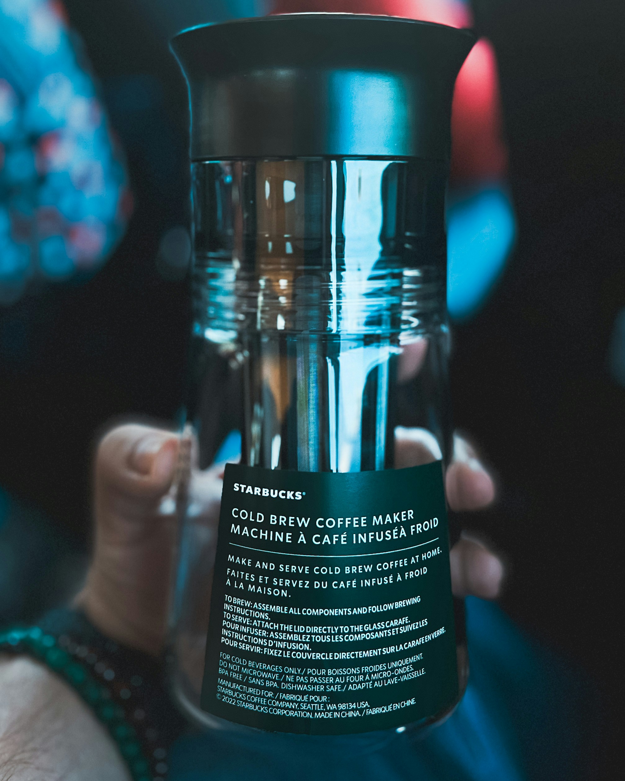Close up of dark cold brew coffee with ice, deep espresso tones, moody restaurant dim lighting