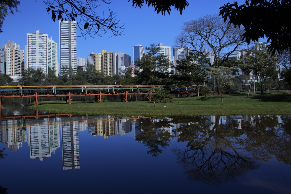 a bridge over a body of water with a city in the background