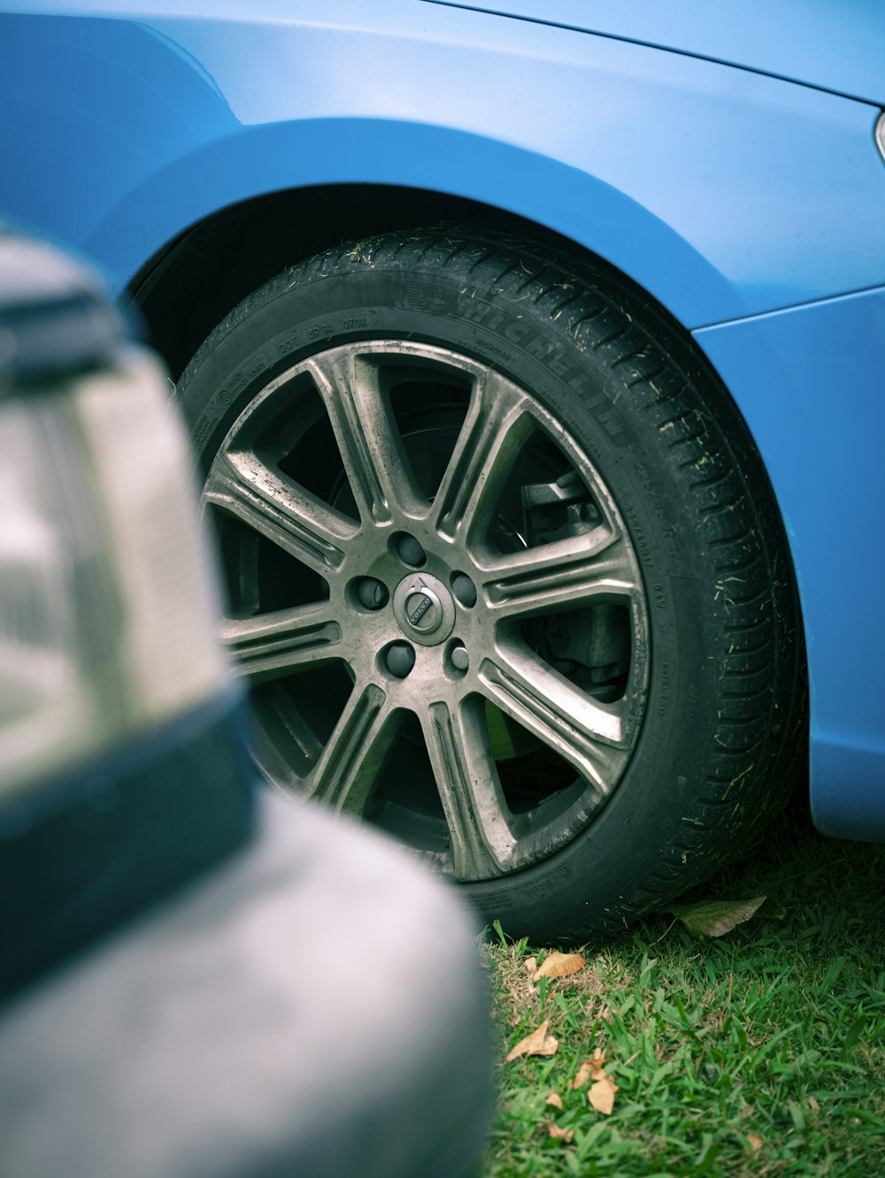 a close up of a car tire on the grass