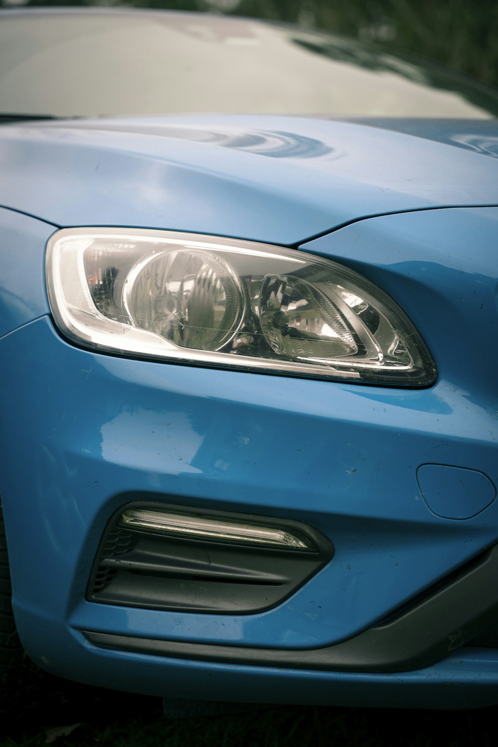 a close up of the front of a blue car