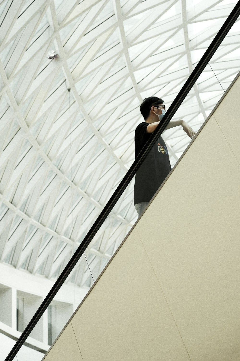 a person standing on a ledge talking on a cell phone