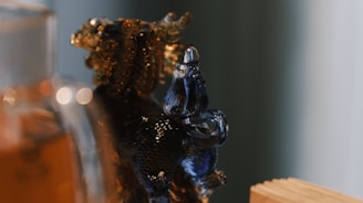 Close-up of a handcrafted colorful glass figure with delicate light reflections.