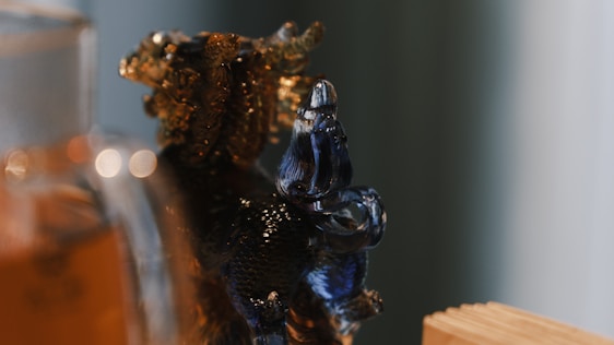 Close-up of a handcrafted colorful glass figure with delicate light reflections.