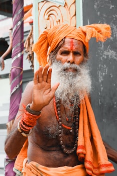 a man with a white beard and orange turban