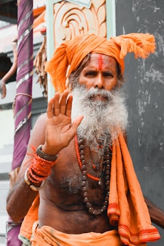 a man with a white beard and orange turban