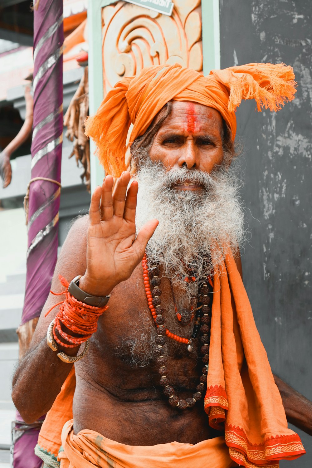 a man with a white beard and orange turban
