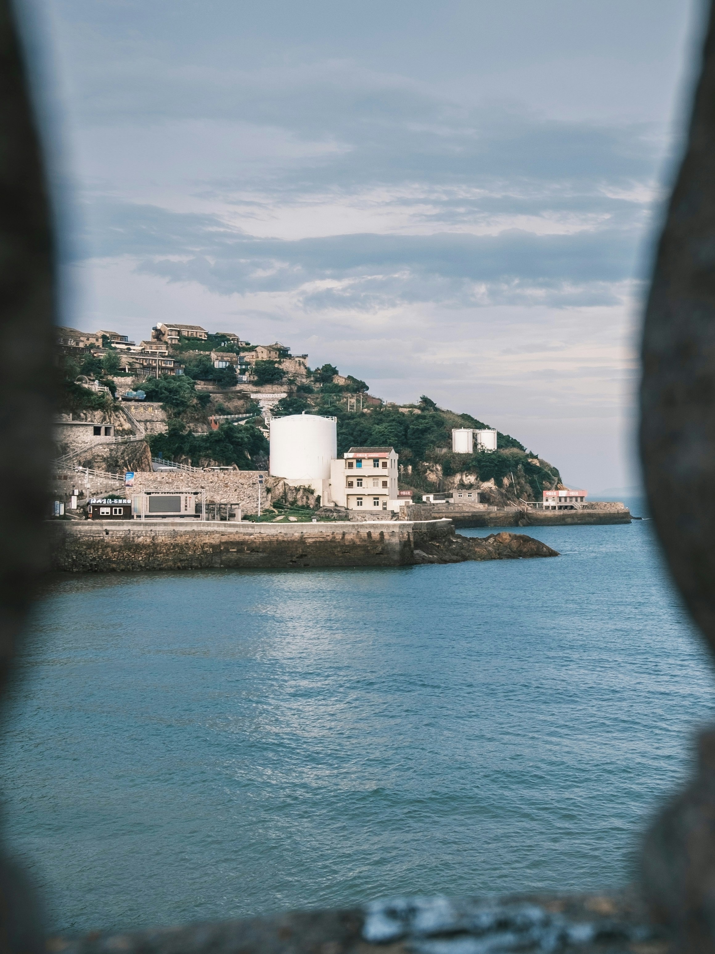 a view of a body of water with a hill in the background