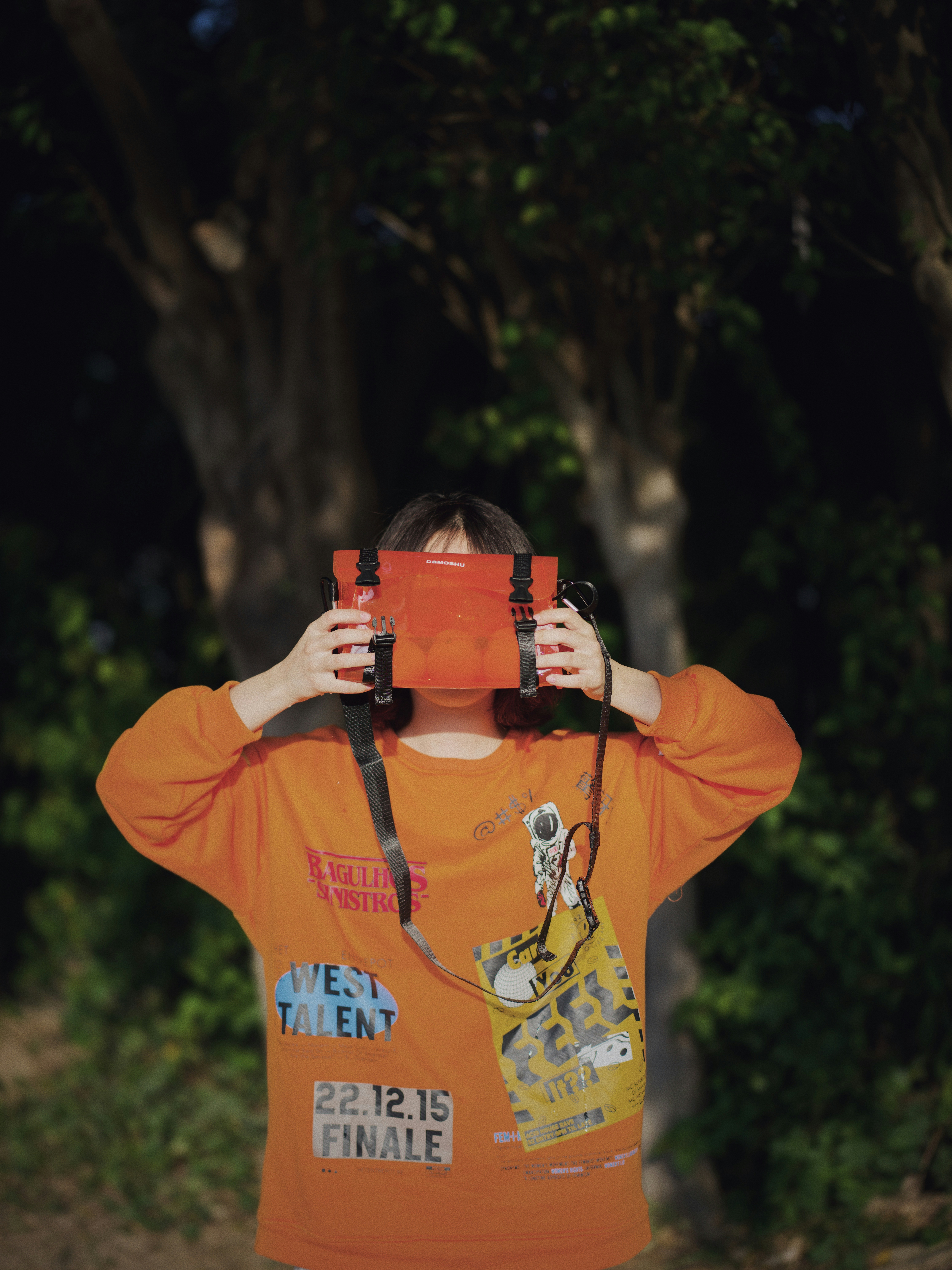 a young boy holding a pair of binoculars up to his face