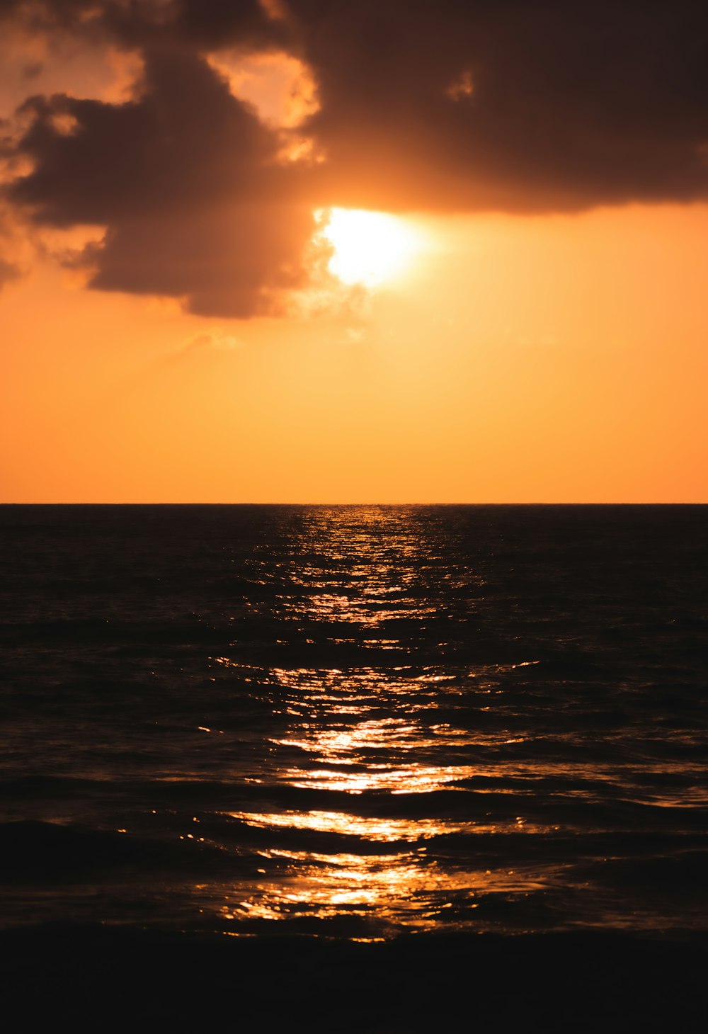 a large body of water under a cloudy sky