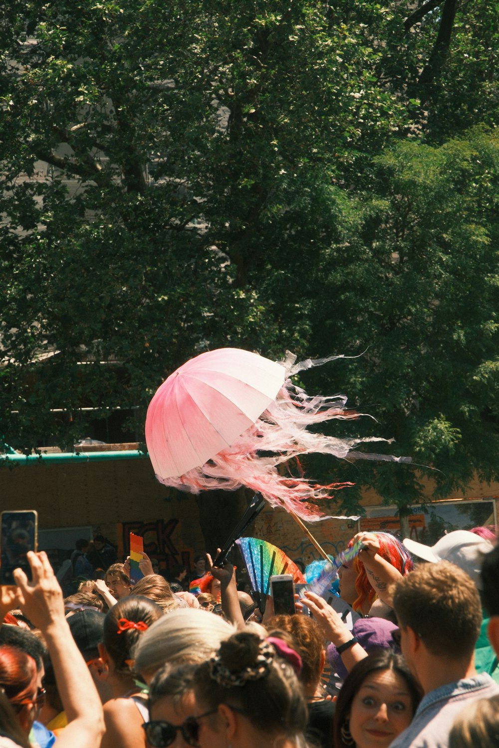 a crowd of people flying kites in the air