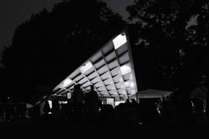 Picture of a temporary outdoor structure with coverings and seating arranged for a public gathering