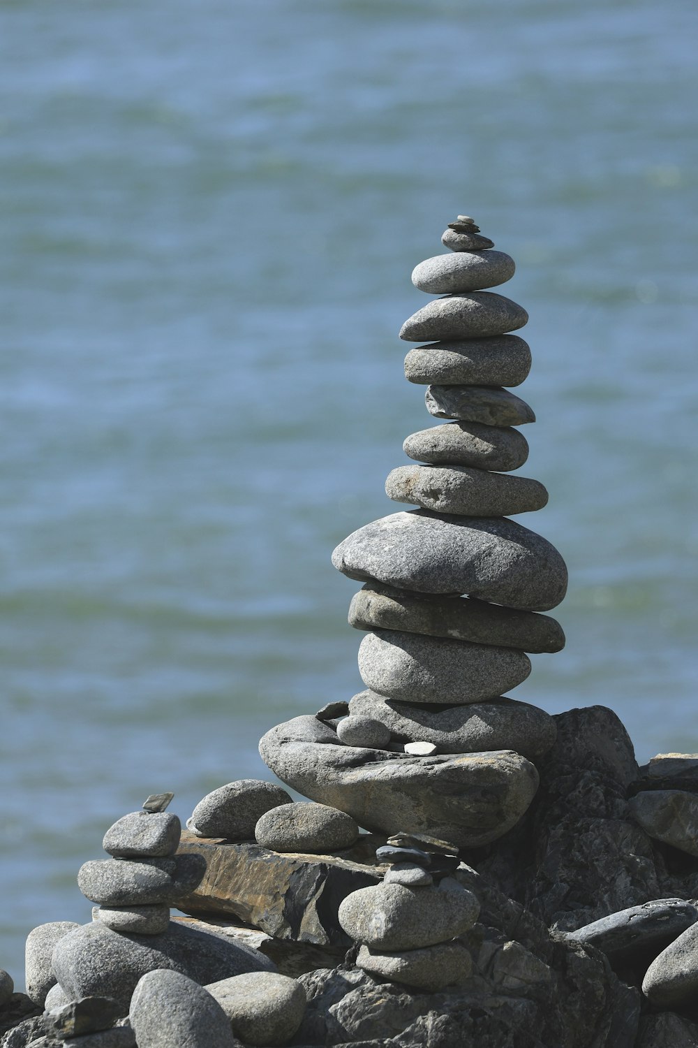 a pile of rocks sitting on top of a beach