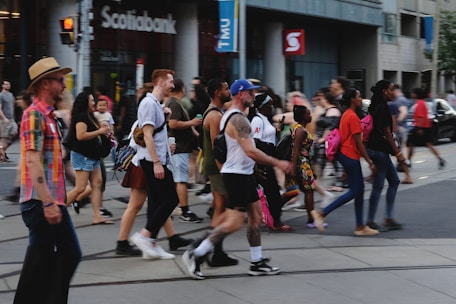 a crowd of people walking across a street